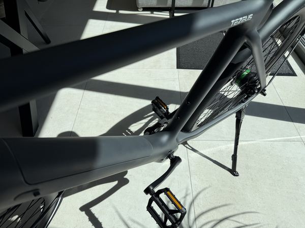 Side view of the Tezeus C8 frame with the TEZEUS branding visible on the top tube
