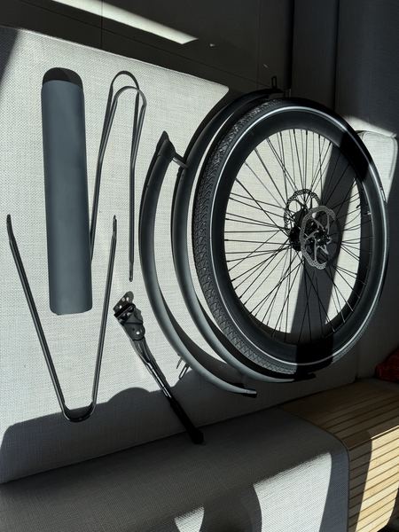 Returned components laid out: front wheel, fenders, battery cover and kickstand