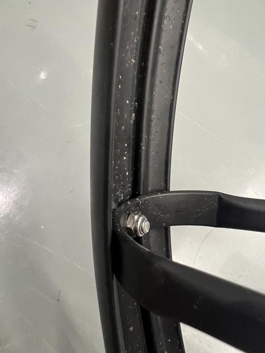 Tezeus installation guide Step 1-3 image showing the rear-fender bracket bolted on the outside (convex side) of the fender